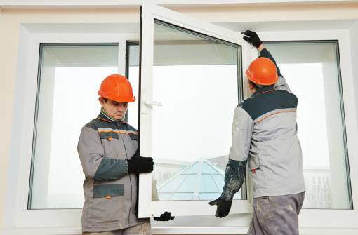 Workers installing glass window
