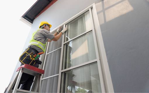 Worker Repairing Glass Window
